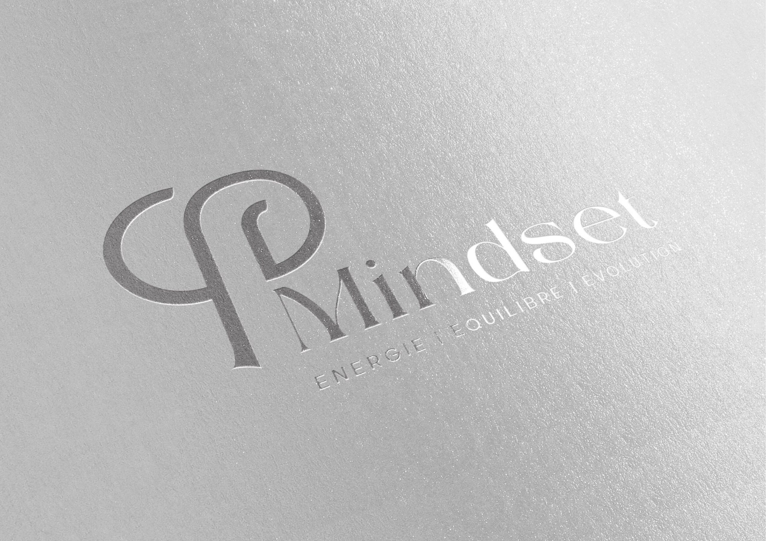 a woman in a black suit holding her head